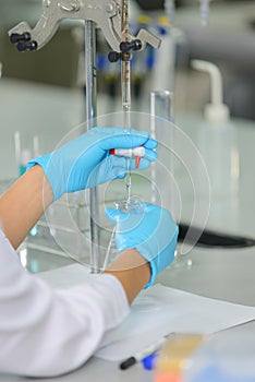 The woman whoÃ¢â¬â¢s the scientist is demonstrate the titration technique